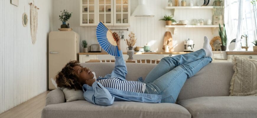 Unhappy,Exhausted,And,Overheated,Young,African,Woman,Lying,On,Sofa